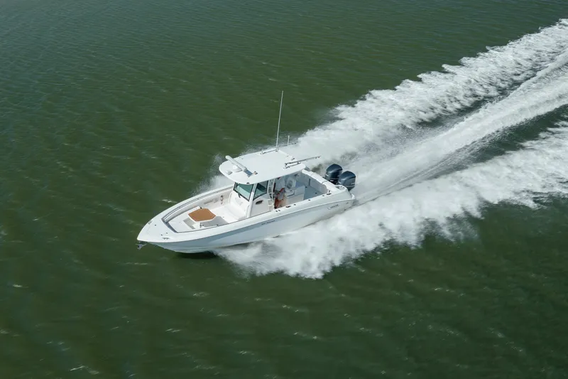Slide: The Image of 2013 Boston Whaler 320 Outrage speeding on open water, creating a dynamic wake. - 6