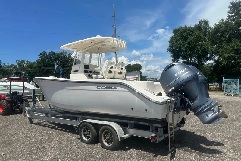 The Image of 2023 Cobia 262 Center Console boat on trailer with Yamaha outboard motor. - 0