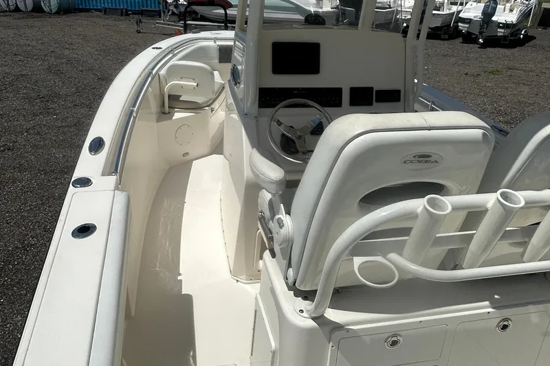 Slide: The Image of 2023 Cobia 262 Center Console boat interior with steering console and seating. - 12