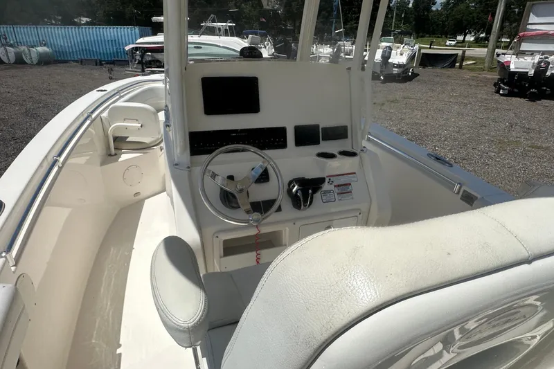 Slide: The Image of 2023 Cobia 262 Center Console boat interior with steering wheel and control panel. - 13