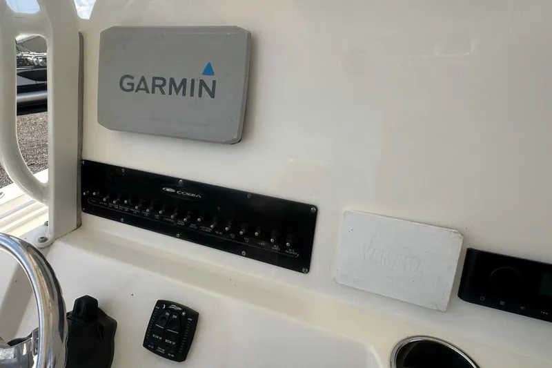 Slide: The Image of 2023 Cobia 262 Center Console dashboard with Garmin navigation system. - 25