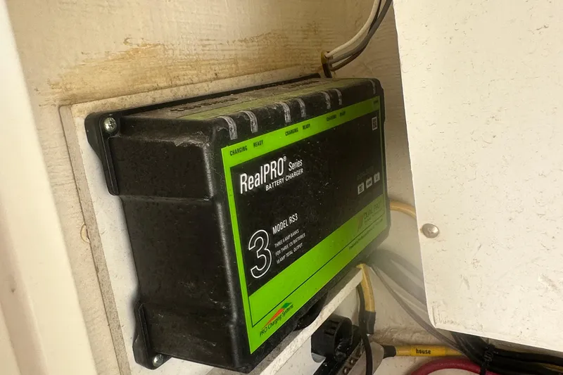 Slide: The Image of Battery charger in 2023 Cobia 262 Center Console boat, RealPRO Series Model RS3. - 26