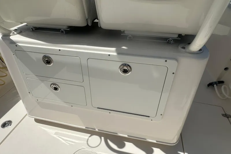 Slide: The Image of 2023 Cobia 262 Center Console storage compartment with secure latches and sleek design. - 32