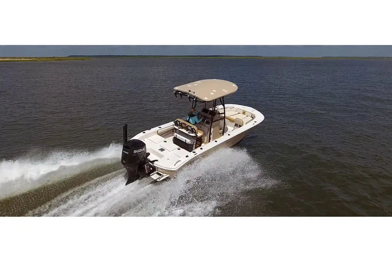 The Image of 2026 Carolina Skiff 22 Ultra Elite boat cruising on open water, rear view. - 1