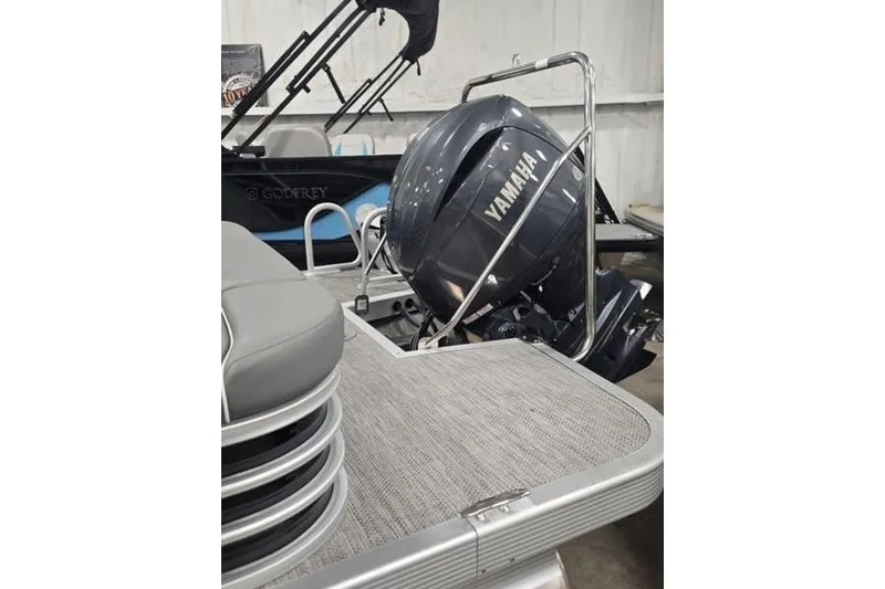 Slide: The Image of 2024 Bennington 22 LSB pontoon boat with Yamaha outboard motor in showroom. - 3