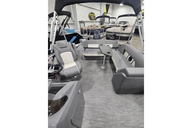 Slide: The Image of 2024 Bennington 22 LSB pontoon boat interior with gray seating and table. - 4