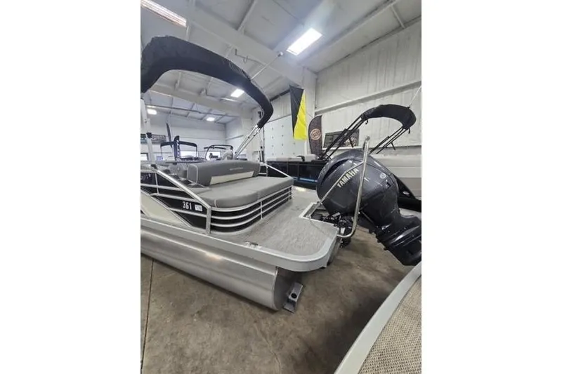Slide: The Image of 2024 Bennington 22 LSB pontoon boat with Yamaha outboard in showroom. - 5