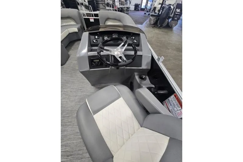 Slide: The Image of 2024 Bennington 22 LSB boat interior with steering wheel and seating. - 6