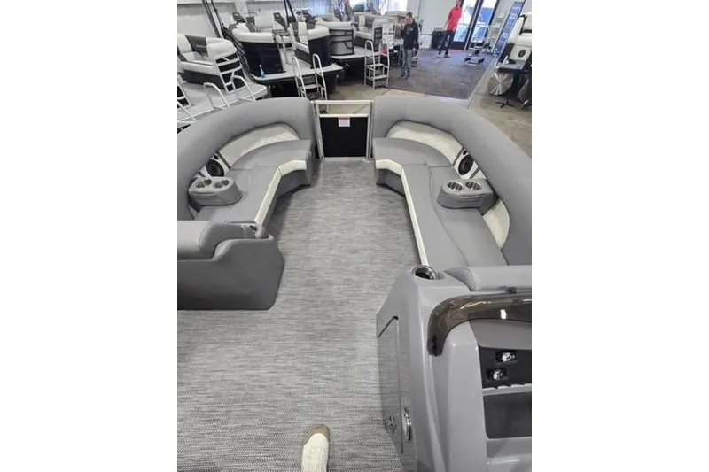 Slide: The Image of 2024 Bennington 22 LSB pontoon boat interior with gray seating and carpet. - 7