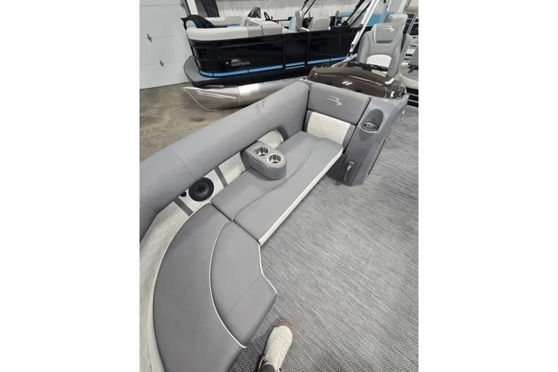 Slide: The Image of 2024 Bennington 22 LSB pontoon boat interior with gray seating and cup holders. - 8