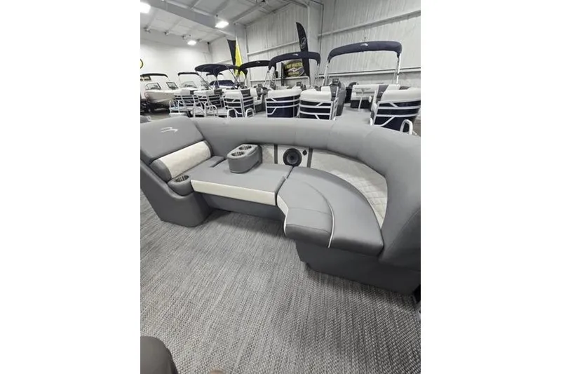 Slide: The Image of 2024 Bennington 22 LSB pontoon boat interior with gray seating and cup holders. - 9
