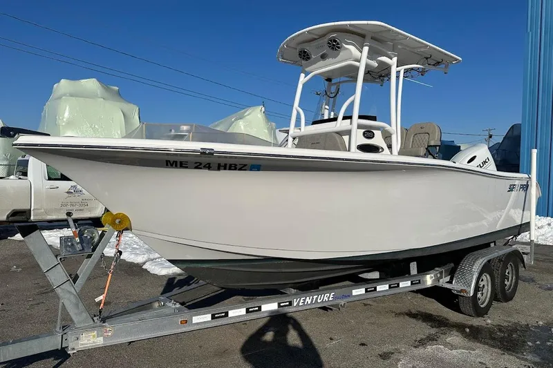 The Image of 2022 Sea Pro 219 Center Console boat on trailer, parked outdoors. - 0