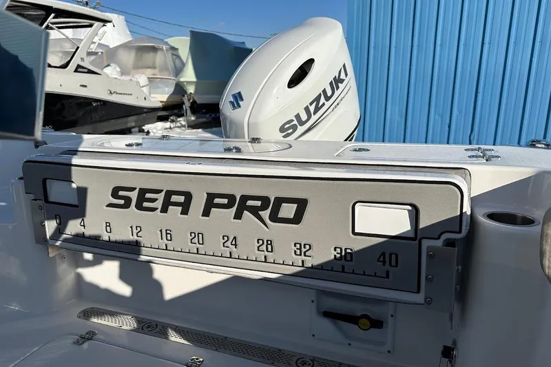 Slide: The Image of 2022 Sea Pro 219 Center Console with Suzuki engine, docked near blue building. - 16
