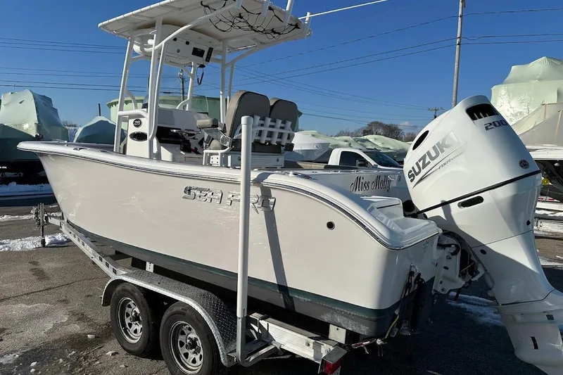 Slide: The Image of 2022 Sea Pro 219 Center Console boat with Suzuki 200 engine on trailer. - 2