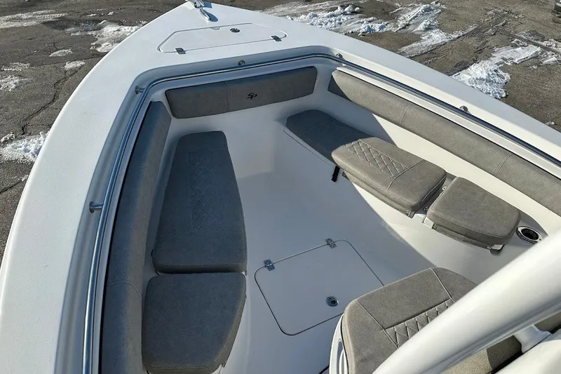 Slide: The Image of 2022 Sea Pro 219 Center Console boat interior with cushioned seating and storage. - 21