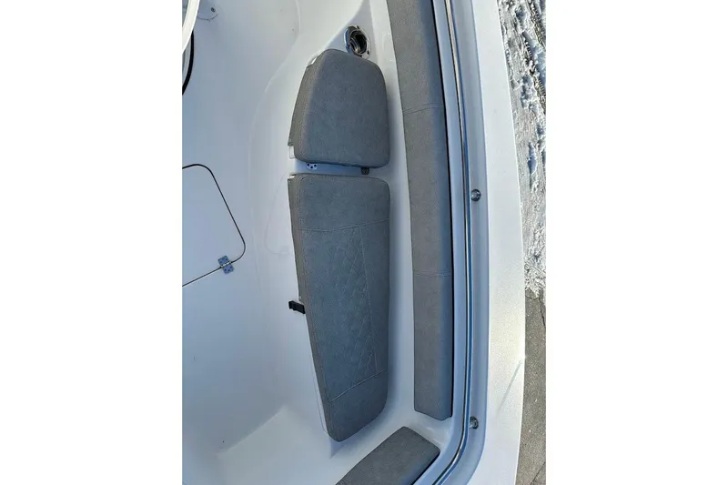 Slide: The Image of 2022 Sea Pro 219 Center Console boat interior seating, featuring gray cushioned seats. - 22