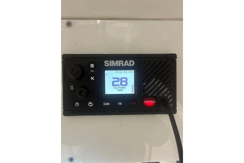 Slide: The Image of Simrad marine radio on 2022 Sea Pro 219 Center Console boat dashboard. - 32