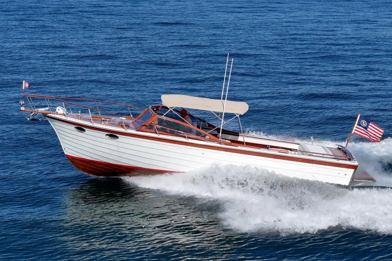 Slide: The Image of 1991 Windsor Craft 31 Sport Cruiser navigating ocean waters at speed. - 1