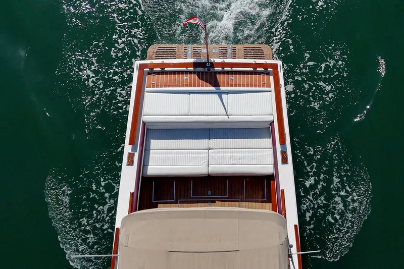 Slide: The Image of Top view of 1991 Windsor Craft 31 Sport Cruiser on water, showcasing deck and seating. - 13