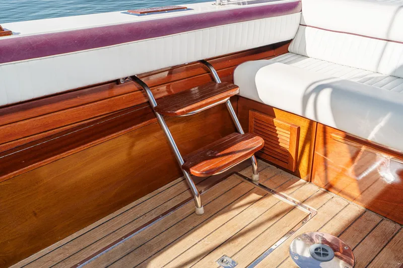 Slide: The Image of Interior of 1991 Windsor Craft 31 Sport Cruiser with wooden steps and seating. - 19
