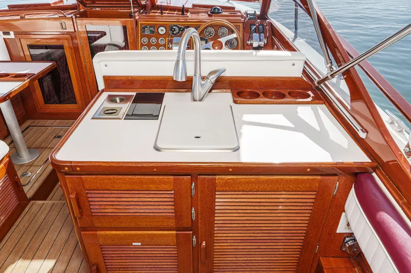 Slide: The Image of Luxurious 1991 Windsor Craft 31 Sport Cruiser interior with wooden cabinetry and modern amenities. - 25