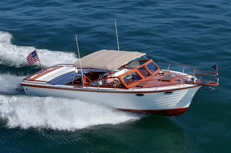 Slide: The Image of 1991 Windsor Craft 31 Sport Cruiser navigating through water, showcasing elegant design and craftsmanship. - 3