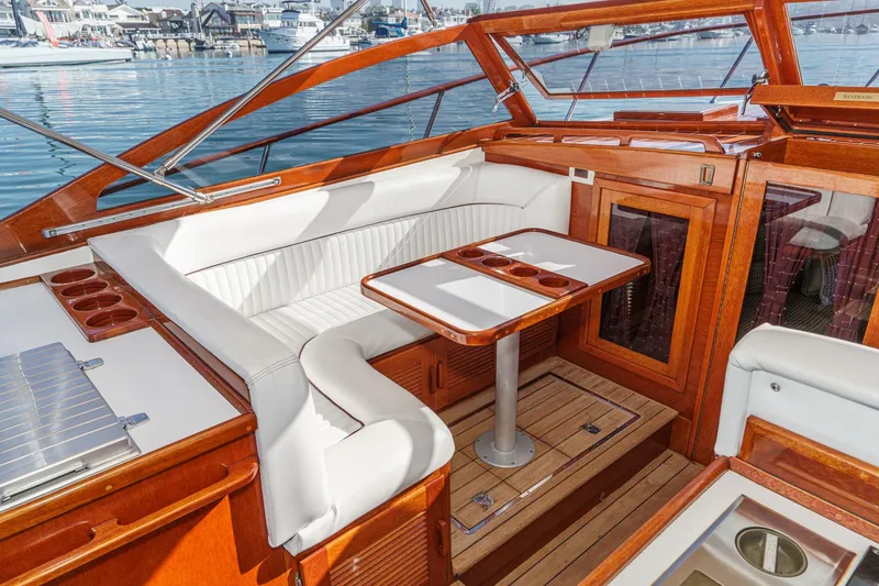 Slide: The Image of Luxurious interior of 1991 Windsor Craft 31 Sport Cruiser with elegant wood and white seating. - 32