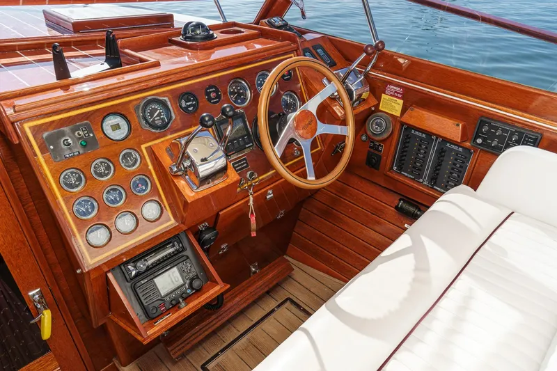 Slide: The Image of 1991 Windsor Craft 31 Sport Cruiser dashboard with wooden finish and classic steering wheel. - 34
