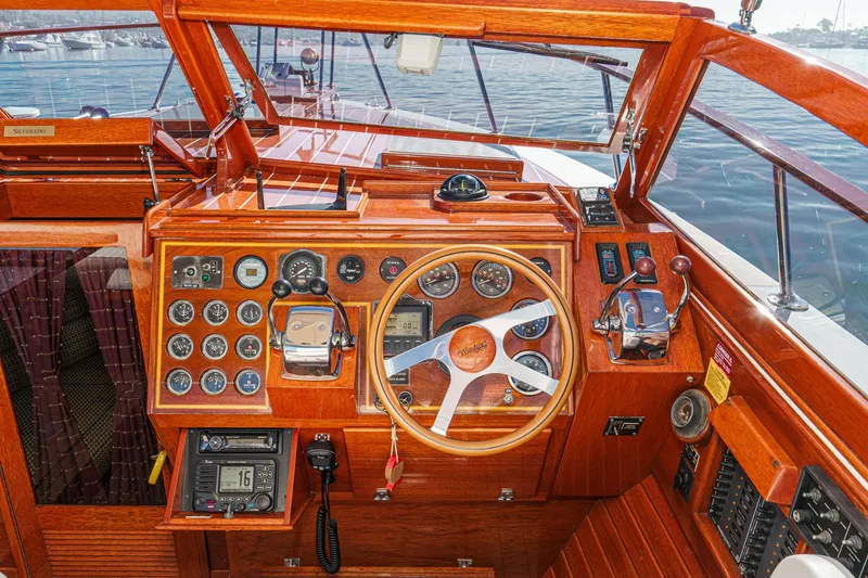 Slide: The Image of Cockpit of 1991 Windsor Craft 31 Sport Cruiser with wooden dashboard and steering wheel. - 35