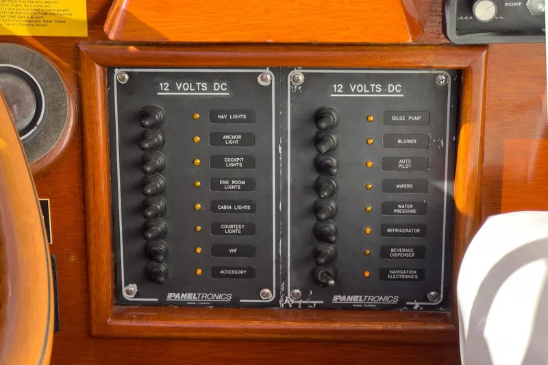 Slide: The Image of Control panel of a 1991 Windsor Craft 31 Sport Cruiser with labeled switches. - 40