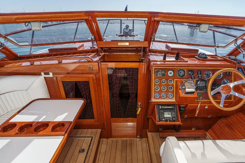 Slide: The Image of Cockpit of 1991 Windsor Craft 31 Sport Cruiser with wooden dashboard and steering wheel. - 42