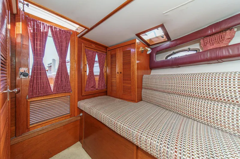Slide: The Image of Interior of 1991 Windsor Craft 31 Sport Cruiser with wood paneling and patterned seating. - 48