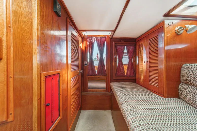 Slide: The Image of Interior of 1991 Windsor Craft 31 Sport Cruiser with wood paneling and patterned seating. - 49