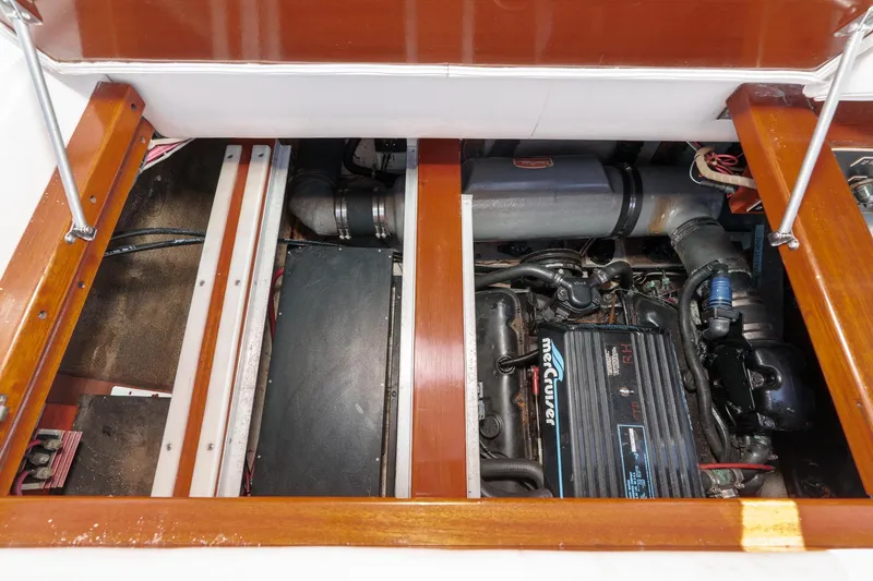 Slide: The Image of Engine compartment of a 1991 Windsor Craft 31 Sport Cruiser, featuring a MerCruiser engine. - 53