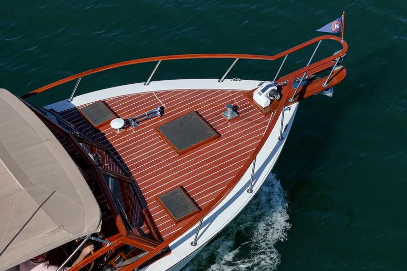 Slide: The Image of 1991 Windsor Craft 31 Sport Cruiser on water, showcasing elegant wooden deck design. - 60