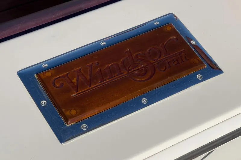 Slide: The Image of Plaque displaying "Windsor Craft" on a 1991 31 Sport Cruiser boat. - 62