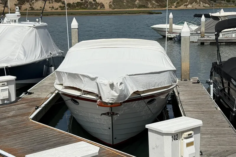 Slide: The Image of Covered 1991 Windsor Craft 31 Sport Cruiser docked at marina. - 65