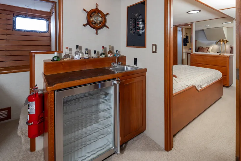 Slide: The Image of 1974 Willard 1201 yacht interior with minibar, sink, and cozy bedroom. - 29
