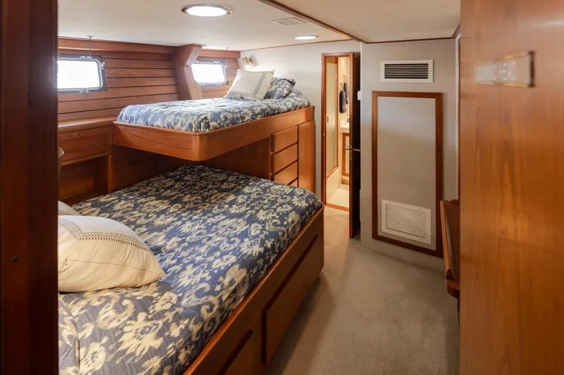 Slide: The Image of Cozy 1974 Willard 1201 yacht cabin with bunk beds and wooden interior. - 31