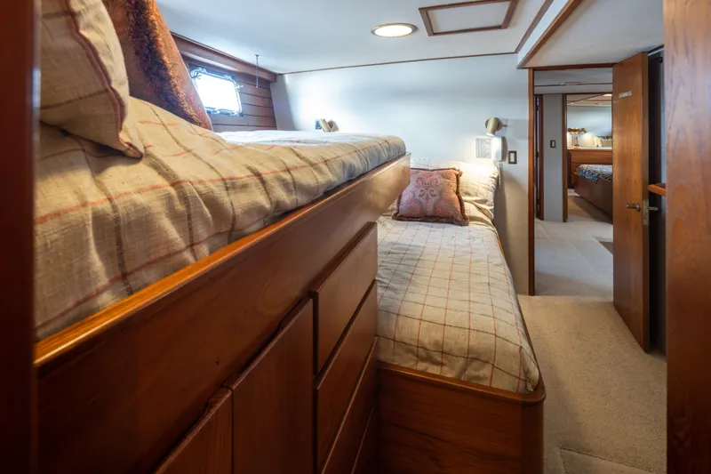 Slide: The Image of Cozy 1974 Willard 1201 yacht interior with bunk beds and wooden furnishings. - 32