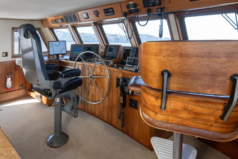 Slide: The Image of Vintage 1974 Willard 1201 boat cockpit with wooden interior and modern navigation equipment. - 46