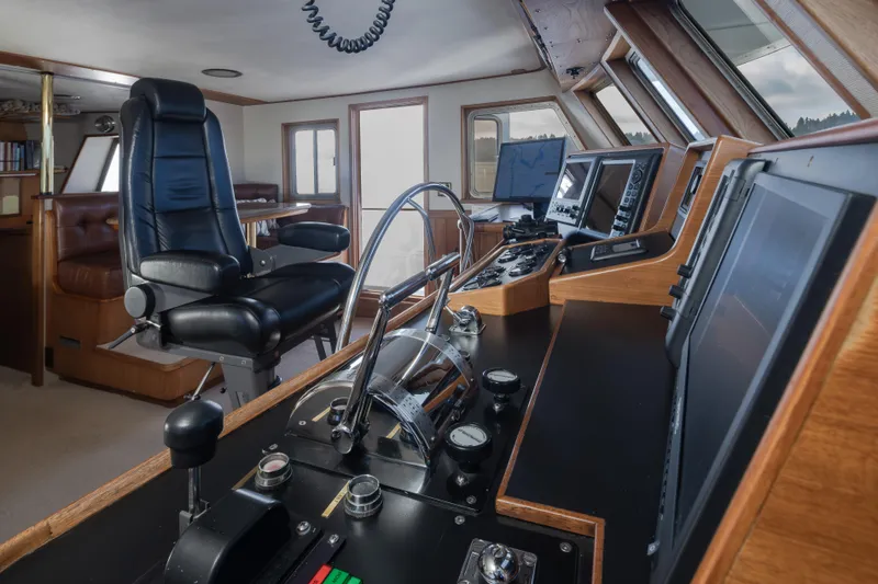 Slide: The Image of Interior of 1974 Willard 1201 boat cockpit with control panels and captain's chair. - 48