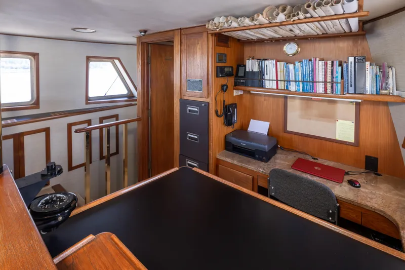Slide: The Image of Cozy 1974 Willard 1201 yacht interior with desk, bookshelves, and navigation tools. - 50