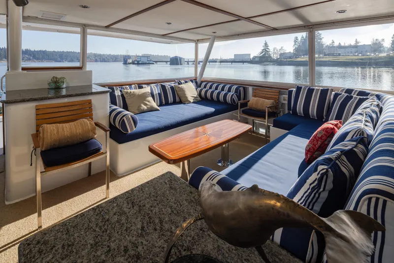Slide: The Image of Luxurious interior of 1974 Willard 1201 yacht with striped seating and scenic water view. - 53