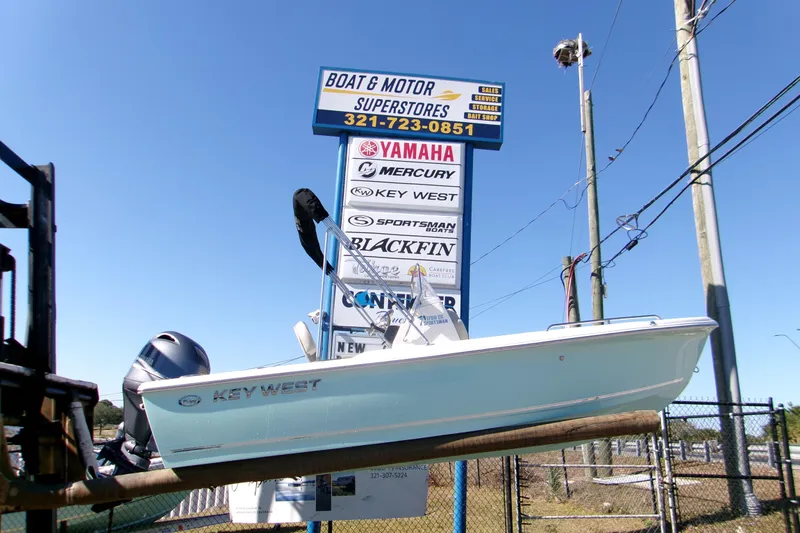 The Image of 2026 Key West 1720 Center Console boat displayed at dealership with signage. - 0