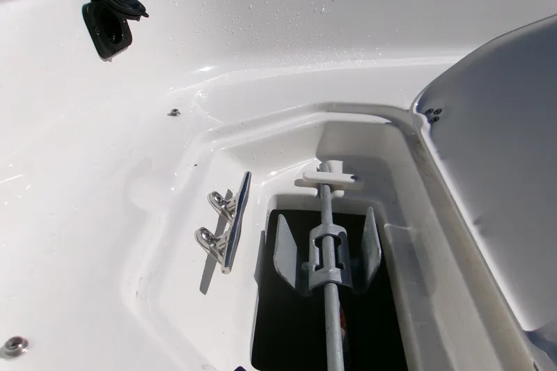 Slide: The Image of Anchor compartment of 2026 Key West 1720 Center Console boat, featuring a cleat and anchor. - 11