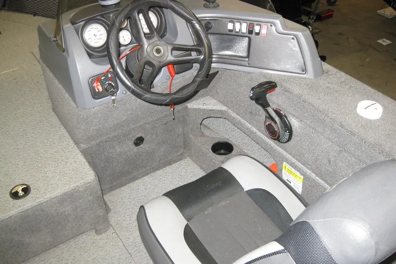 Slide: The Image of 2016 Lund 1775 Impact SS boat interior with steering wheel and control panel. - 10
