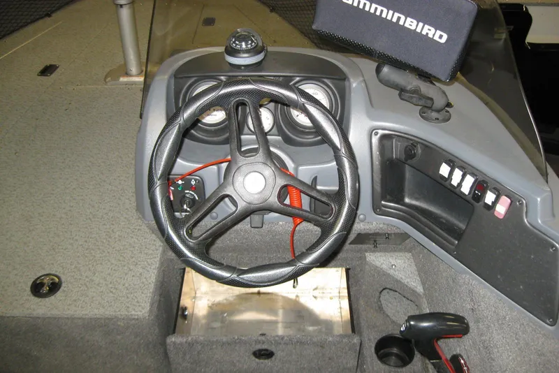 Slide: The Image of 2016 Lund 1775 Impact SS boat dashboard with steering wheel and control panel. - 11