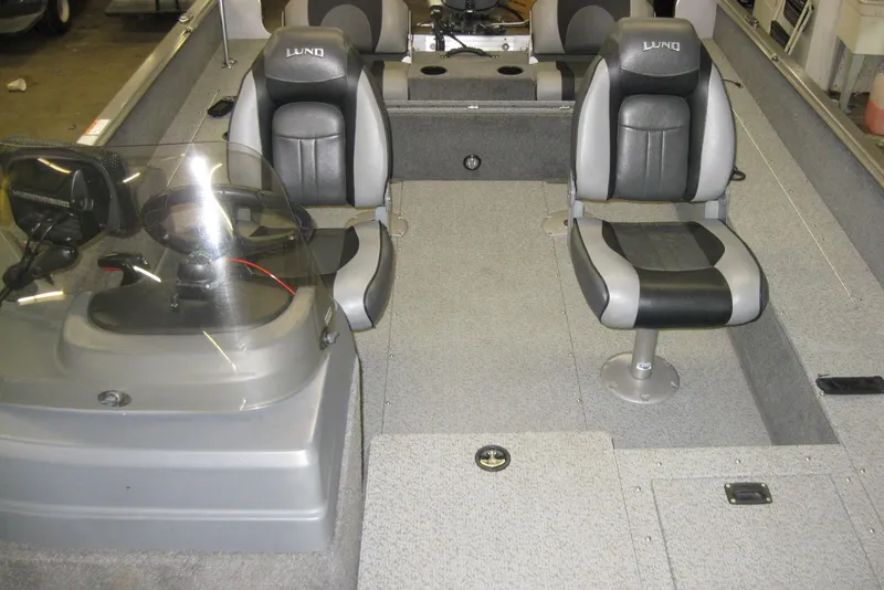 Slide: The Image of 2016 Lund 1775 Impact SS boat interior with seating and steering console. - 13