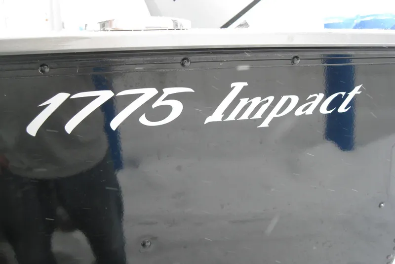 Slide: The Image of 2016 Lund 1775 Impact SS boat model name on black hull. - 3